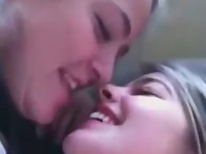 Teen girls giggle while they kiss