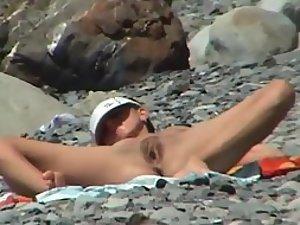 Inviting pose of a naked beach girl