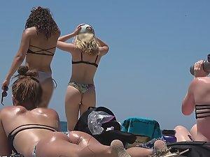 Teens bending over in front of me on beach Picture 3