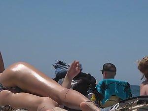 Teens bending over in front of me on beach Picture 6