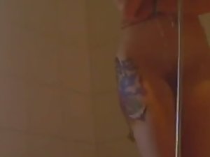 Tattooed girl voyeured in the shower
