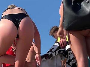 Hottie in thong bikini bends over a lot on beach Picture 6