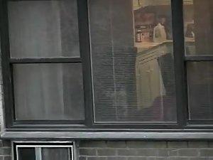 Topless neighbor girl in a window peep Picture 4