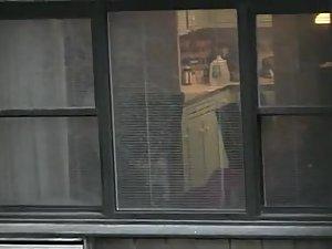 Topless neighbor girl in a window peep Picture 5