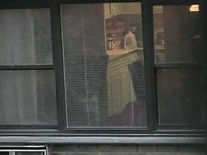 Topless neighbor girl in a window peep Picture 6