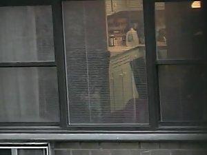 Topless neighbor girl in a window peep Picture 7