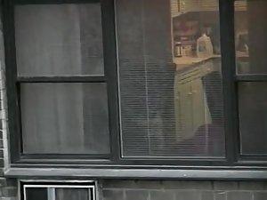 Topless neighbor girl in a window peep Picture 8