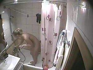 Young blonde girl caught in a shower Picture 2