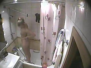 Young blonde girl caught in a shower Picture 3