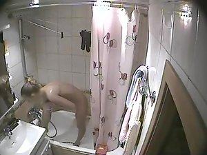 Young blonde girl caught in a shower Picture 4