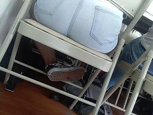 Schoolgirl's ass peeks out of chair Picture 1
