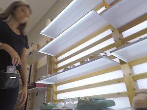 Sexy salesgirl in all black outfit in the store Picture 4