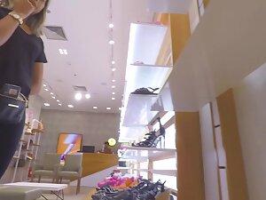 Sexy salesgirl in all black outfit in the store