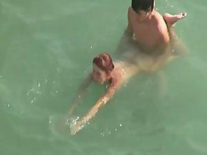 Horny couple trying to fuck in the water Picture 1