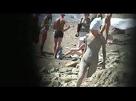 Muddy naked girl on a crowded beach Picture 5