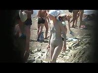 Muddy naked girl on a crowded beach Picture 7