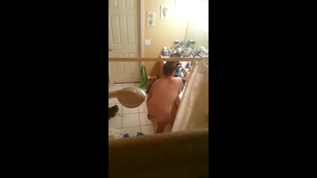 Peeping on big naked woman through window image