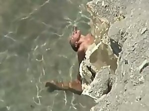 Peeping on sex in the water behind rocks