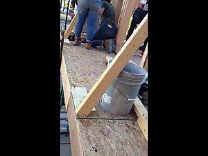 Construction worker woman bends over in jeans Picture 1