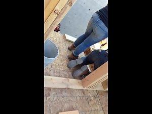 Construction worker woman bends over in jeans Picture 2
