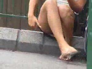 Upskirt of a girl sitting on a road curb Picture 8