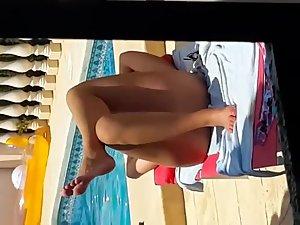 Naked milf relaxes by a private pool Picture 3