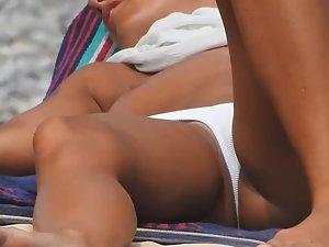 Tanned blonde relaxes in topless Picture 6