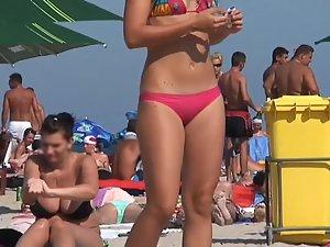 Sexy girl dancing and chewing candy on beach Picture 3