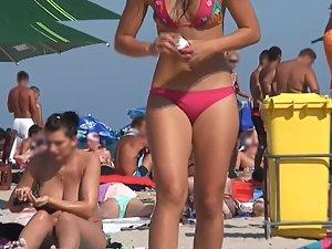 Sexy girl dancing and chewing candy on beach Picture 4