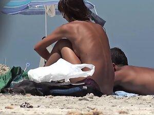 Beach voyeur spies on extra tanned nudist girl Picture 1