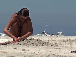 Beach voyeur spies on extra tanned nudist girl Picture 3