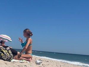Petite girl in a very sexy pose on the beach Picture 1