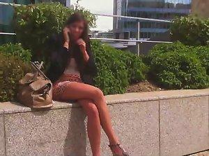 Leggy girl sitting on a wall Picture 7