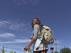 Upskirt of nerdy black girl in short skirt