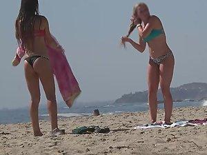 Hot teens play frisbee on the beach