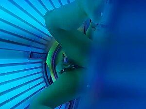 Peeping on hottie fingering pussy within tanning machine Picture 2