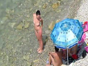 Spying a nudist family on the beach Picture 4
