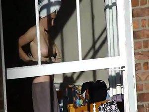 Voyeur peeps her tits through a window Picture 3