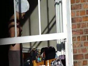 Voyeur peeps her tits through a window Picture 7