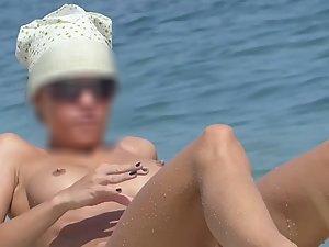 Nudist girl finally bends over on beach Picture 2