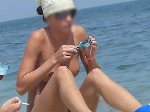Nudist girl finally bends over on beach Picture 3