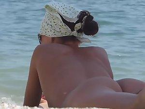 Nudist girl finally bends over on beach Picture 8