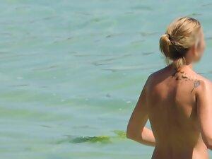 Perky tits of topless woman entering the water Picture 4