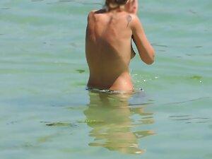 Perky tits of topless woman entering the water Picture 6