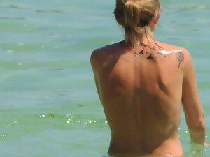 Perky tits of topless woman entering the water Picture 7