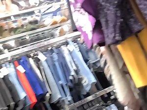 Fit girl in gym outfit is shopping for clothes Picture 1