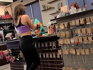 Fit girl in gym outfit is shopping for clothes Picture 7
