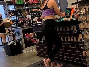 Fit girl in gym outfit is shopping for clothes Picture 8
