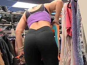 Fit girl in gym outfit is shopping for clothes