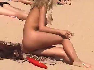 Blonde nudist girl smoking a cigarette Picture 2